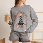 St. Augustine Saints Crewneck Sweatshirt in sport grey with the black and white striped lighthouse emblem with gold rays on the front, worn by model