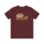 Clovis Pioneers Premium Lightweight T-Shirt in maroon with the Clovis Pioneers logo, a ballplayer with a raised bat riding a horse-drawn covered wagon, with Pioneers on the canvas on the front
