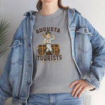 Augusta Tourists Heavyweight T-Shirt in sport grey with the cartoon ballplayer with a bat standing on a travel trunk on the front, worn by model