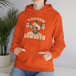 Tucson Cowboys Hoodie in orange with the Tucson Cowboys logo, a cowboy in front of a saguaro with 1941 and 1953 pennant banners on the front, worn by model