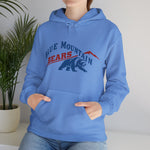 Blue Mountain Bears Hoodie in carolina blue with the Blue Mountain Bears logo, a snarling bear below a red mountain peak on the front, worn by model