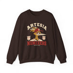 Artesia Numexers Crewneck Sweatshirt in dark chocolate with the Artesia Numexers logo, a roadrunner in a red A cap between Longhorn League and 1954 Champions banners, with Numexers in red block letters on the front