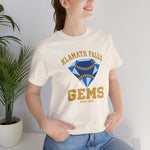 Klamath Falls Gems Premium Lightweight T-Shirt in natural with the Klamath Falls Gems logo, a blue diamond gem with baseball stitching on the front, worn by model