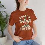 Tucson Cowboys Premium Lightweight T-Shirt in autumn with the Tucson Cowboys logo, a cowboy in front of a saguaro with 1941 and 1953 pennant banners on the front, worn by model