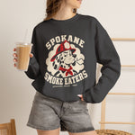 Spokane Smoke Eaters Crewneck Sweatshirt in dark heather with the Spokane Smoke Eaters logo, a Dalmatian in a red fire helmet and bandana blowing smoke on the front, worn by model