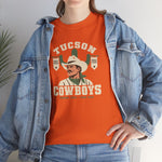 Tucson Cowboys Heavyweight T-Shirt in orange with the Tucson Cowboys logo, a cowboy in front of a saguaro with 1941 and 1953 pennant banners on the front, worn by model
