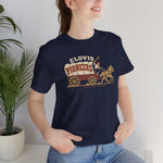 Clovis Pioneers Premium Lightweight T-Shirt in navy with the Clovis Pioneers logo, a ballplayer with a raised bat riding a horse-drawn covered wagon, with Pioneers on the canvas on the front, worn by model