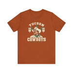 Tucson Cowboys Premium Lightweight T-Shirt in autumn with the Tucson Cowboys logo, a cowboy in front of a saguaro with 1941 and 1953 pennant banners on the front