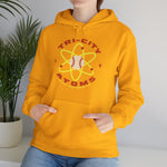 Tri-City Atoms Hoodie in gold with the Tri-City Atoms logo, a baseball at the center of a yellow atom with orbiting electrons on the front, worn by model