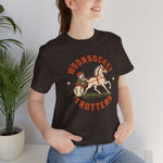 Woonsocket Trotters Premium Lightweight T-Shirt in brown with the Woonsocket Trotters logo, a harness racing driver in a baseball cap behind a trotting horse, the sulky wheel drawn as a baseball on the front, worn by model