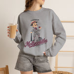 Tonopah Mollycoddles Crewneck Sweatshirt in sport grey with the Tonopah Mollycoddles logo, a monocled deadball-era dandy holding a teacup and leaning on his bat on the front, worn by model