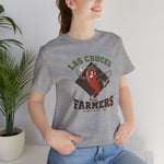 Las Cruces Farmers Premium Lightweight T-Shirt in athletic heather with the Las Cruces Farmers logo, a red chile pepper pitcher in a high-kick windup on a brown diamond, with Farmers in brown block letters on the front, worn by model
