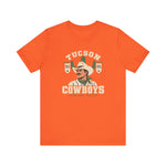 Tucson Cowboys Premium Lightweight T-Shirt in orange with the Tucson Cowboys logo, a cowboy in front of a saguaro with 1941 and 1953 pennant banners on the front