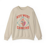 Key West Conchs Crewneck Sweatshirt in sand with the grinning striped conch shell mascot inside a teal diamond outline on the front